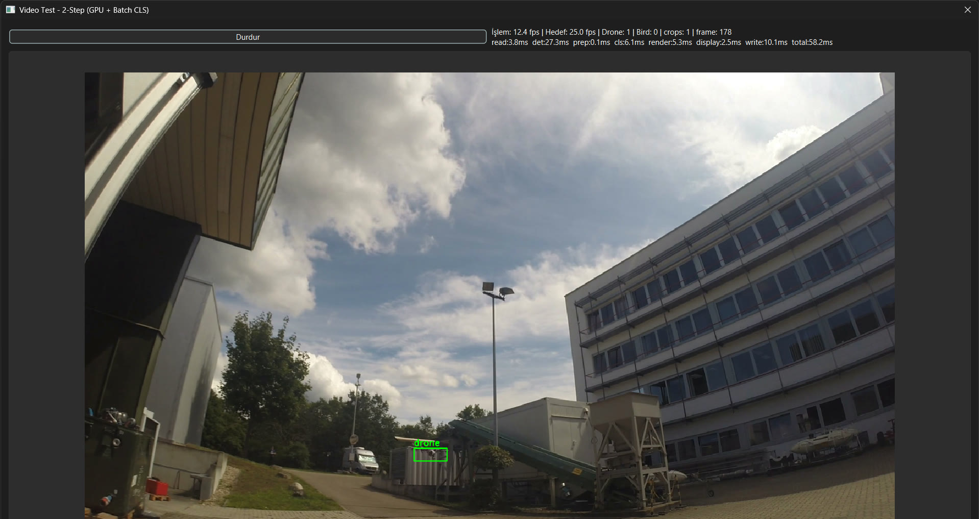 The Video Test – 2-Step (GPU + Batch CLS) window. A drone low over buildings is marked in a green box; the processing rate and stage times are written above.